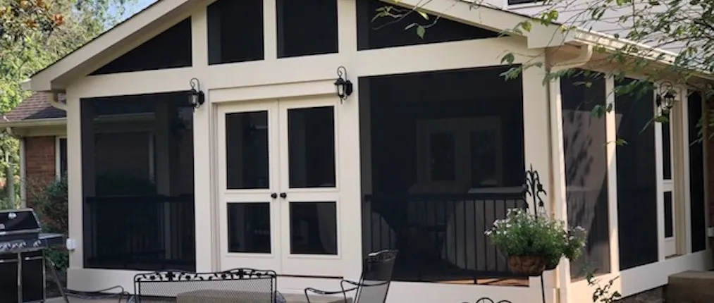 Screen room with white double French doors and transom panels under a gable